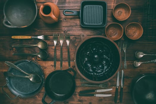 Kitchen utensils, cooking tools, on wooden background. Vintage kitchenware collection.