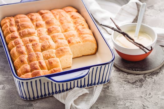 Buchteln, sweet rolls made of yeast dough with milk and butter, served with vanilla sauce. Traditional meatless dish in Europe