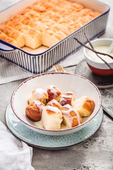 Buchteln, sweet rolls made of yeast dough with milk and butter, served with vanilla sauce. Traditional meatless dish in Europe