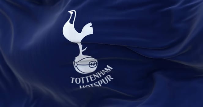 London, UK, Feb 2023: Tottenham Hotspur flag waving. White cockerel standing on a football. Rippled fabric background. Illustrative editorial 3d illustration render. Selective focus. Close-up