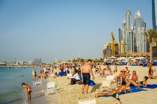 Dubai, UAE, February 23, 2018: Crowded beach at Jumeirah Beach Residence in Dubai, UAE