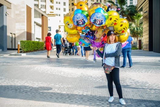 Dubai, UAE, February 23, 2018: A party balloon vendor at the Jumeirah Beach Residence (JBR) Walk - a polular destination for food, shopping and entertainment