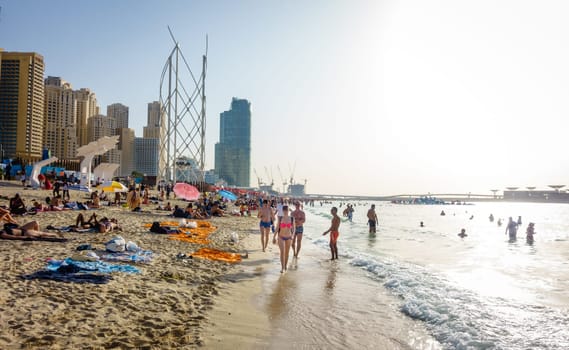 Dubai, UAE, February 23, 2018: Crowded beach at Jumeirah Beach Residence in Dubai, UAE