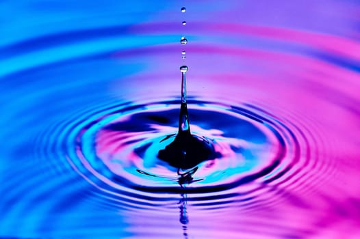 a drop of water falling into the water and creating waves. High quality photo