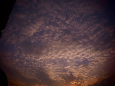 Pink, red, purple sunset sky cloud. Dramatic sunset sky. Wonderful sunset. Clouds in the evening sky. The sun's rays pierce the clouds. Beautiful landscape. The sun goes down.