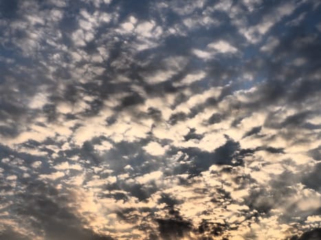 Black, gray and yellow sunset sky cloud. Dramatic sunset sky. Wonderful sunset. Clouds in the evening sky. The sun's rays pierce the clouds. Beautiful landscape. The sun goes down