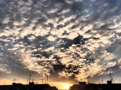 Black, gray and yellow sunset sky cloud. Dramatic sunset sky. Wonderful sunset. Clouds in the evening sky. The sun's rays pierce the clouds. Beautiful landscape. The sun goes down