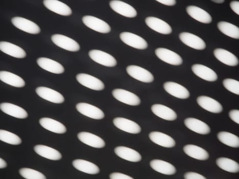 abstract sun bunnies ovals. Black and white trendy ugly. Retro or disco style. Abstract background with different blurred sun glare passing through the holes of the blinds or shutters.