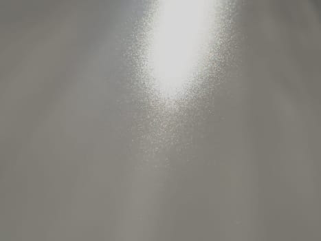 Diagonal rays of light on a gray background. Blurred abstract background light effect, light leaks. Side surface illumination. Small sparks and glow. Shine, glint or glare. Right top left down.