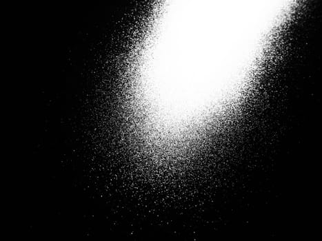 White bokeh and beam on a black background. Blurred glow from above on a dark surface. Night or space theme. Bokeh for the holiday. Abstract background. Glare, ray and light shine from above.