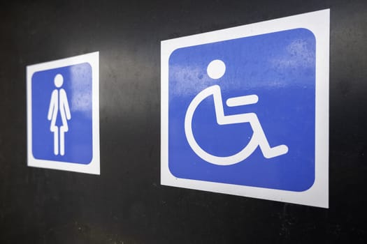 Sign detail for handicapped access in a public bathroom in the city