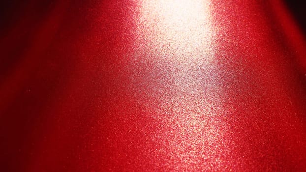 Diagonal rays of light on a red or scarlet background. Blurred abstract background light effect, light leaks. Side surface illumination. Parallel and asymmetric lines or stripes of light at an angle