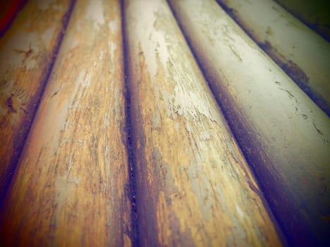 A construction log for use in construction without longitudinal sawing. Round timber assortment. Fragment of the construction of rounded wooden logs. The effect of moisture on wood. Dark vignetting.