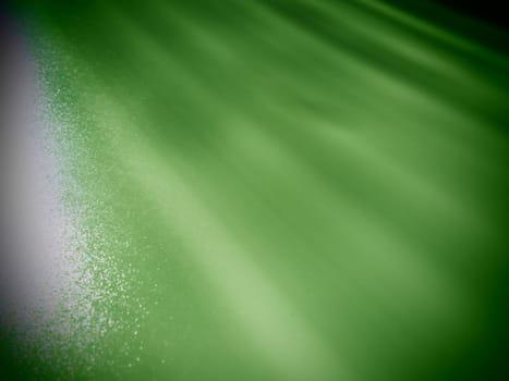 Diagonal rays of light on a green background. Blurred abstract background light effect and leaks. Side surface illumination. Parallel and asymmetric lines or stripes at an angle. Dark vignetting.