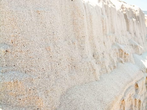 cliffs sand grains. In front of a mountain of sand