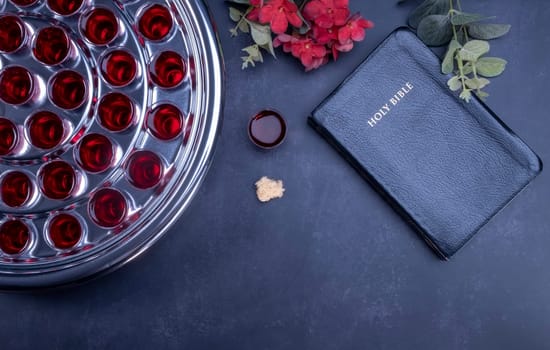 Taking communion concept - the wine and the bread symbols of Jesus Christ blood and body with Holy Bible. Easter Passover and Lord Supper concept.