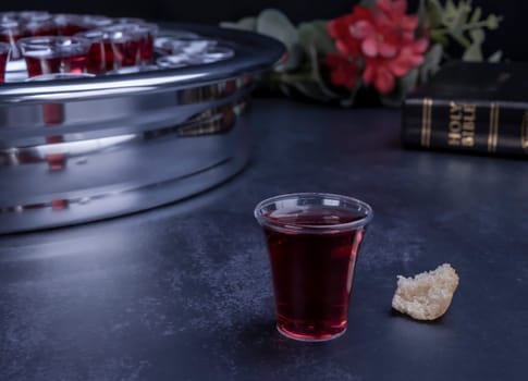 Taking communion concept - the wine and the bread symbols of Jesus Christ blood and body with Holy Bible. Easter Passover and Lord Supper concept.