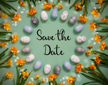 Flat Lay With English Text Save The Date. Easter Egg Decoration With Orange Spring Flowers. Light Green Paper Background With Bright And Shiny Light Effect.