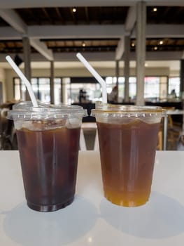 Iced americano with orange and iced americano in coffee shop, stock photo