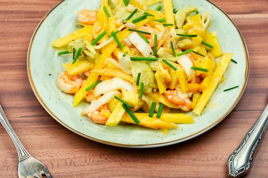 Dieting fresh salad with prawns, mango, avocado and pine nuts.