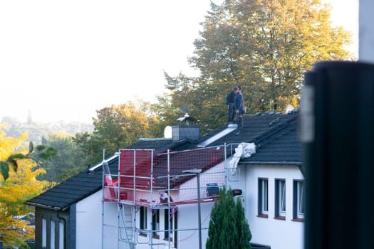 HEILIGENHAUS, NRW, GERMANY - OKTOBER 06, 2022:.Heiligenhaus, Nrw, Germany - Oktober 06, 2022:.Closeup of house roof top covered with ceramic shingles. Tiled covering of building
