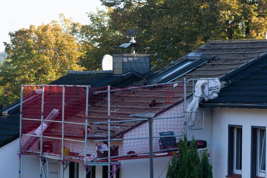 HEILIGENHAUS, NRW, GERMANY - OKTOBER 06, 2022:.Heiligenhaus, Nrw, Germany - Oktober 06, 2022:.Closeup of house roof top covered with ceramic shingles. Tiled covering of building