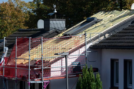 HEILIGENHAUS, NRW, GERMANY - OKTOBER 06, 2022:.Heiligenhaus, Nrw, Germany - Oktober 06, 2022:.Closeup of house roof top covered with ceramic shingles. Tiled covering of building