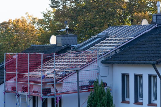 HEILIGENHAUS, NRW, GERMANY - OKTOBER 07, 2022:.Heiligenhaus, Nrw, Germany - Oktober 07, 2022:.Closeup of house roof top covered with ceramic shingles. Tiled covering of building