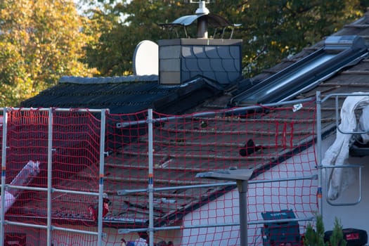 HEILIGENHAUS, NRW, GERMANY - OKTOBER 06, 2022:.Heiligenhaus, Nrw, Germany - Oktober 06, 2022:.Closeup of house roof top covered with ceramic shingles. Tiled covering of building