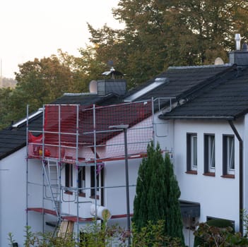 HEILIGENHAUS, NRW, GERMANY - MARCH 05, 2023:.Heiligenhaus, Nrw, Germany - March 05, 2023:.Closeup of house roof top covered with ceramic shingles. Tiled covering of building