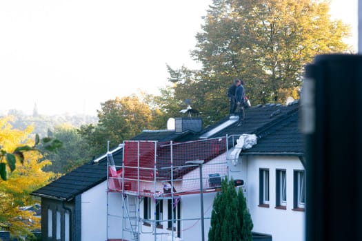 HEILIGENHAUS, NRW, GERMANY - OKTOBER 06, 2022:.Heiligenhaus, Nrw, Germany - Oktober 06, 2022:.Closeup of house roof top covered with ceramic shingles. Tiled covering of building