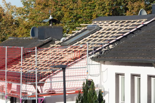 HEILIGENHAUS, NRW, GERMANY - OKTOBER 07, 2022:.Heiligenhaus, Nrw, Germany - Oktober 07, 2022:.Closeup of house roof top covered with ceramic shingles. Tiled covering of building