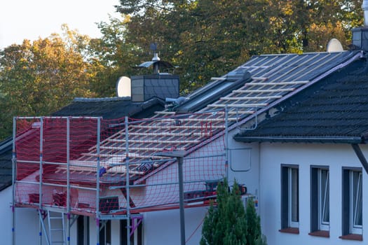 HEILIGENHAUS, NRW, GERMANY - OKTOBER 07, 2022:.Heiligenhaus, Nrw, Germany - Oktober 07, 2022:.Closeup of house roof top covered with ceramic shingles. Tiled covering of building