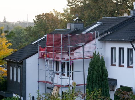 HEILIGENHAUS, NRW, GERMANY - MARCH 05, 2023:.Heiligenhaus, Nrw, Germany - March 05, 2023:.Closeup of house roof top covered with ceramic shingles. Tiled covering of building