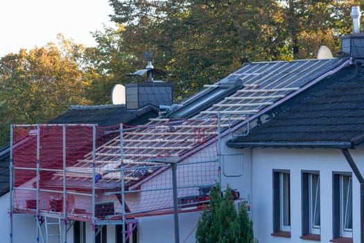 HEILIGENHAUS, NRW, GERMANY - OKTOBER 07, 2022:.Heiligenhaus, Nrw, Germany - Oktober 07, 2022:.Closeup of house roof top covered with ceramic shingles. Tiled covering of building