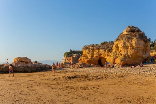 Ferragudo, Portugal - 25 August 2025: Beautiful seascape with beach, cave and ocean. Praia Grande beach. Ferragudo, Lagoa, Algarve, Portugal