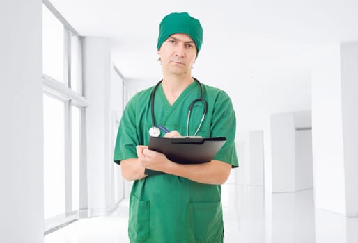 male doctor thinking with his notes, at the hospital