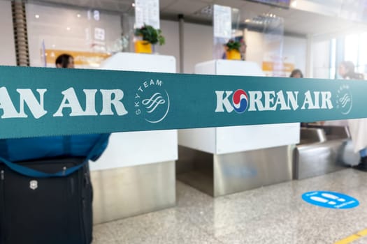 Seoul, KR, Jan 2023: Cyan barrier tape with the Korean Air logo inside an airport. Korean Air is the flag carrier of South Korea. Travel and airport security. Illustrative editorial