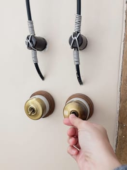 Hand on metal door holder, stock photo