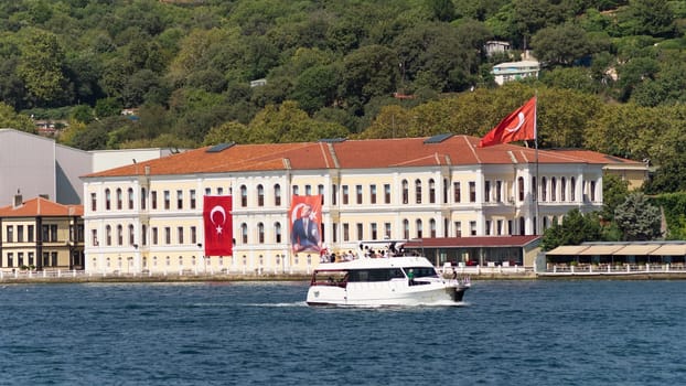 Istanbul, Turkey - August 29, 2022: Morning view in a sunny day of Kabatas Erkek Lisesi building, or Kabatas High School, suited by Bosphorus Strait in Ortakoy, Besiktas