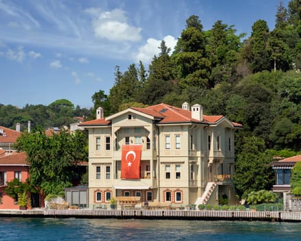 View from Bosphorus strait of the green mountains of the Asian side, with traditional house and dense trees in a summer day, Istanbul, Turkey