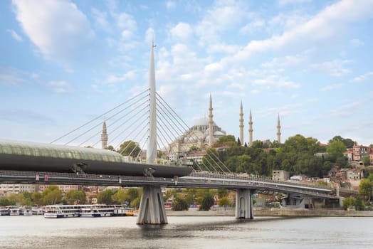 Day shot of Golden Horn Metro Bridge, or Halic Bridge, overlapping Suleymaniye Mosque, Istanbul, Turkey