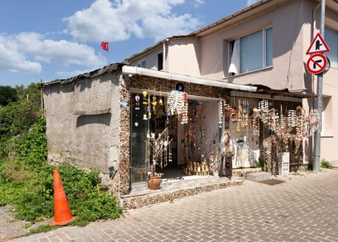 Storefront of souvenir store, with hanged handmade crafts made of sea shells, suited in Anadolu Kavagi district, Istanbul, Turkey