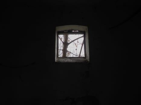 Scary walls with cobwebs. Old church dormer. A small window at the top of the wall. Halloween or haunted place. Prison cell with torture ropes. Visions and a world of hallucinations
