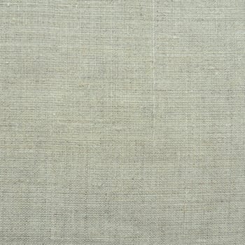 Fabric texture background. Light gray fabric with weave. Natural slightly wrinkled look of the material. Uniform copy space background. Cotton, canvas or woolen thin fabric laid evenly on the surface