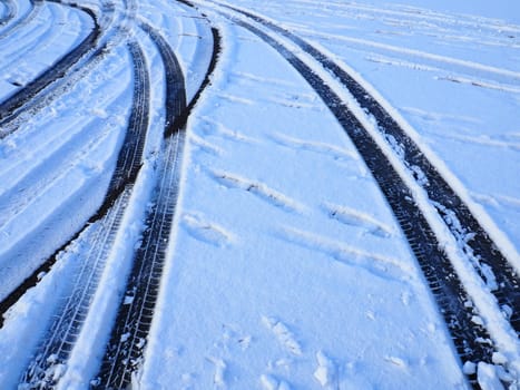 Snowdrifts on the side of the road. Bad weather and traffic. Snow on asphalt. Difficult driving conditions. Winter slosh on the road. Braking distance of a car