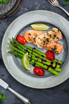 Baked trout and boiled asparagus on the plate