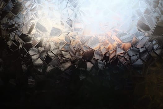 Fluted glass with backlight. Beautiful multicolored refraction of light. Abstract background. Self-adhesive film. Ribbed glass surface. Embossed glass background.