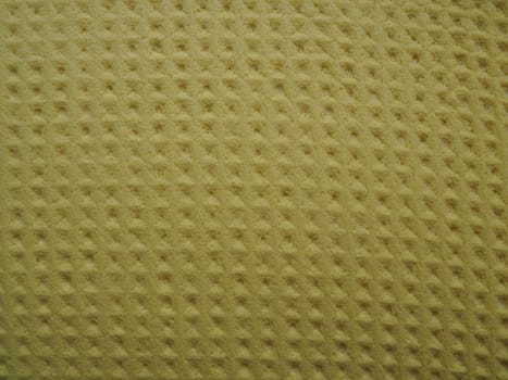 Sponge fibers sponge texture pattern surface close-up yellow brown background.