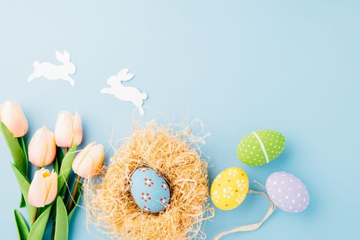 Happy Easter Day Concept. Flat lay of holiday banner background web design easter eggs in brown nest on white cement background with empty copy space, celebration greeting card, overhead, template